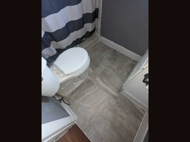 Bathroom tile floor by Fix it Once Handyman Services — New porcelain plank tile laid and grouted