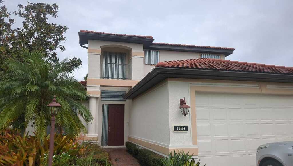 Exterior house paint by Fix It Once Handyman Services — Two-tone stucco refresh on a Venice tile-roof home