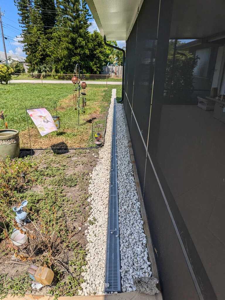 French drain install by Fix It Once Handyman Services — Trench, gravel and grate to keep water off the lanai