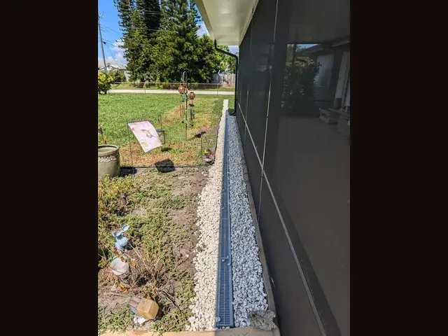 French drain install by Fix it Once Handyman Services — Trench, gravel and grate to keep water off the lanai